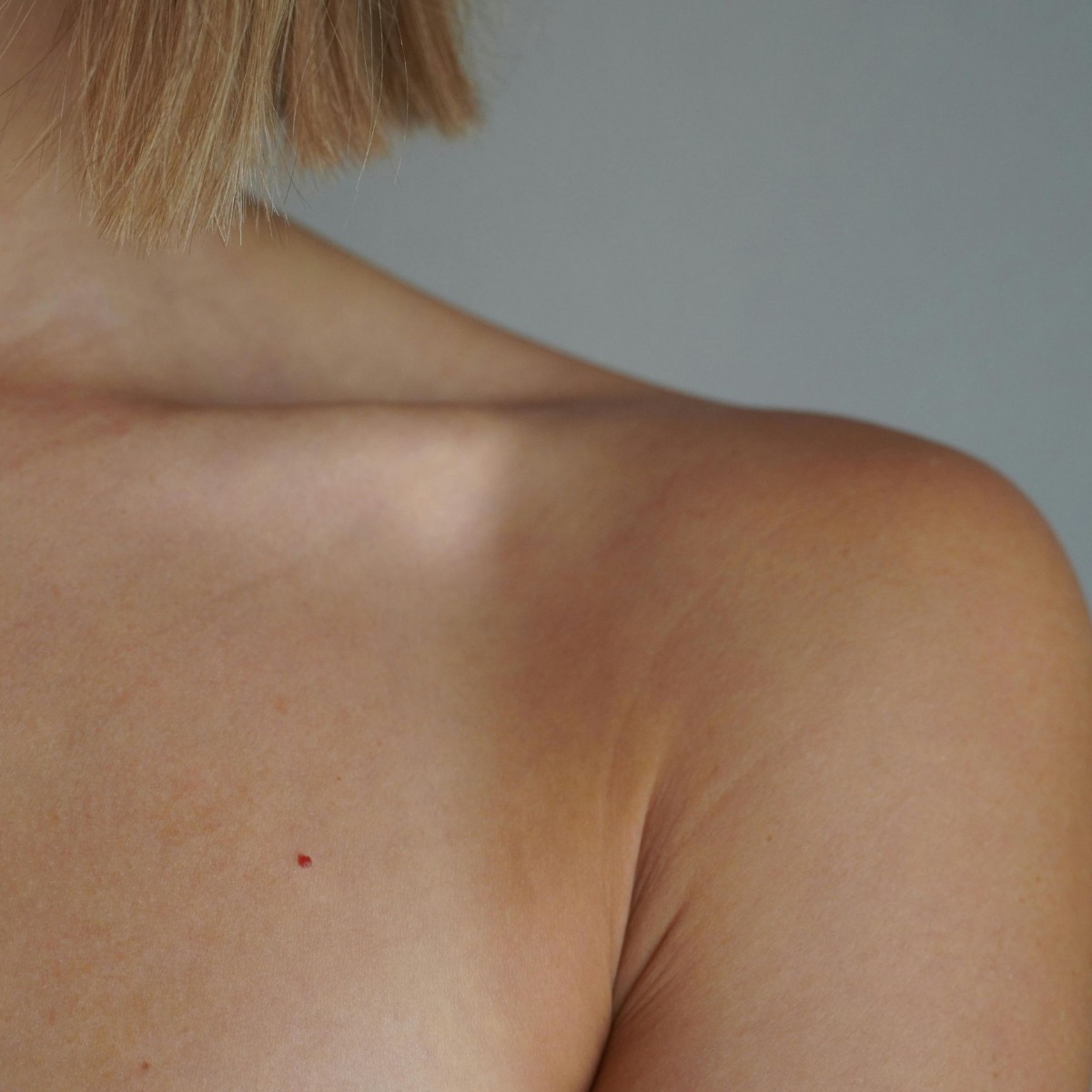Confident woman with smooth skin after electrolysis breast hair removal in NYC