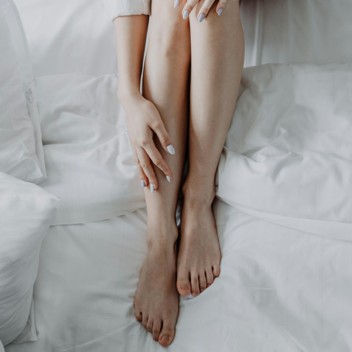 Woman showcasing smooth legs after permanent leg hair removal NYC via electrolysis at Nios Spa